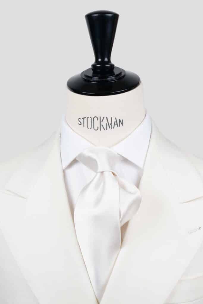 White silk tie in silk satin, three fold, close-up view of the knot, Dare in Paris